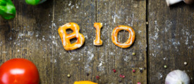 dough letters and vegetables on rustic wooden table with flour german word bio which means organic